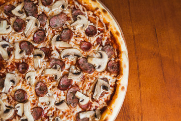 elicious pizza with meat, cheese and mushrooms