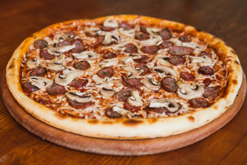 elicious pizza with meat, cheese and mushrooms