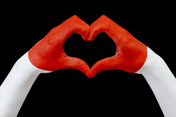 Hands flag of Monaco, shape a heart. Concept of country symbol, isolated on black.