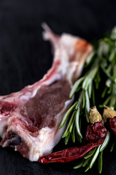 Raw lamb ribs on black background