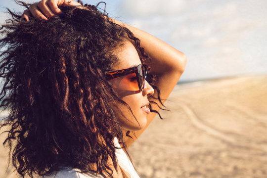 Young afro american woman in sunglasses enjoying sun