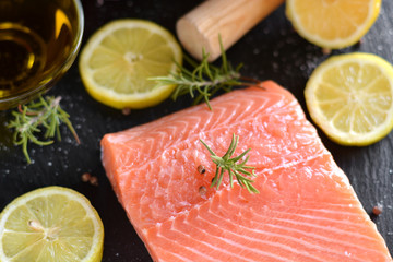 Raw salmon fillets served with lemon