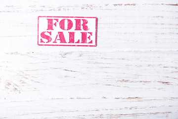 Sale sign on wooden background