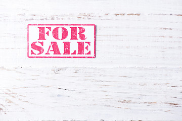 Sale sign on wooden background