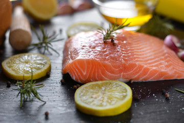 Raw salmon fillets served with lemon