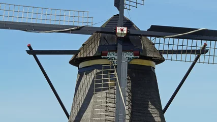Row of mills in Kinderdijk, Netherlands. This cover nineteen mills in the northwest of the Alblasserwaard, in the Green Heart of Holland. Since 1997 they have been on UNESCO World Heritage List.