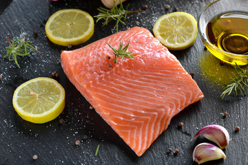 Raw salmon fillets served with lemon