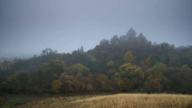 Viscri fortified church at sunrise. Fog rises as the sun appears. Transylvania, Romania.