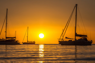 sunset between boats