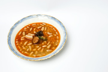 Stew of beans with chorizo and pork.Isolated