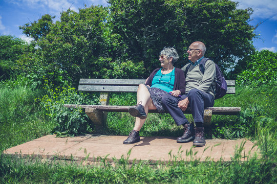Senior couple relaxing on bench in nature