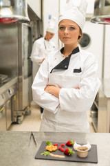 Portrait of young female chef in restaurant