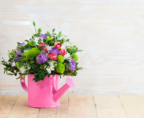 bouquet of flowers in watering can