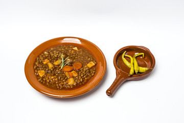 Stew of lentils with chorizo and pork.Isolated