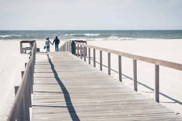 Obraz premium Young couple at sea, European beach with couple in love, loving couple on their honeymoon by sea