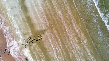 Aerial view on sunny beach at a low tide. Auckland, New Zealand