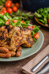 Grilled chicken wings and sausages