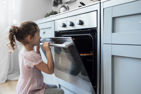 Girl looking into oven