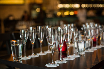 Wine glasses stand on the table, dishes.