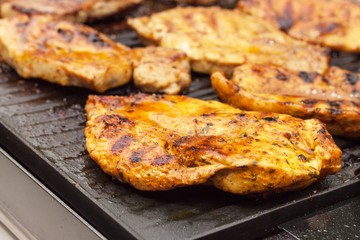 Chicken on electric grill. Summer barbecue. Close-up view.