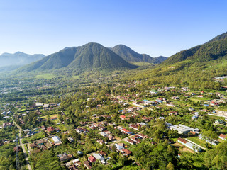 Fototapeta premium Aerial view of Ruteng with volcanoes in the background on the island of East Nusa Tenggara, Indonesia.