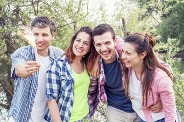 group of friends having fun outdoor on a summer sunset
