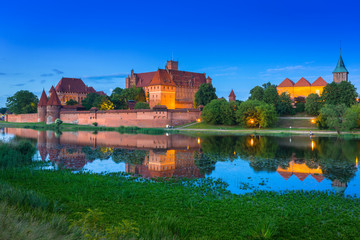 Naklejka na ściany i meble The Castle of the Teutonic Order in Malbork at dusk, Poland
