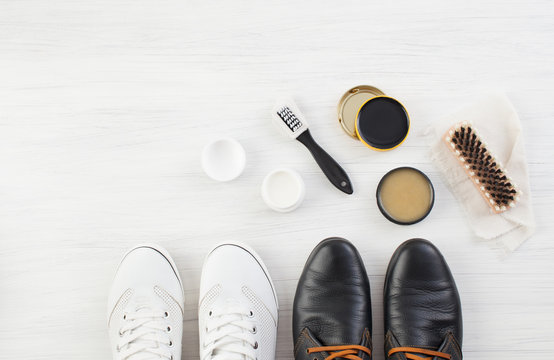 Two Pairs Of Shoes, Shoe Polish And Brush On White