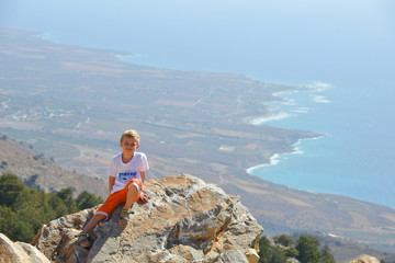 boy on top of mountain