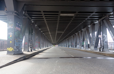 Empty road under steel bridge in industrial area in Hamburg