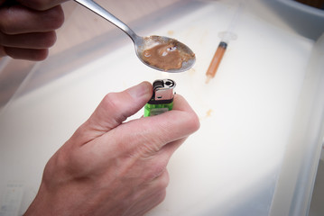 drugs and substance abuse, cooked heroin and syringe