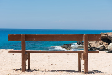 Fototapeta na wymiar Wooden empty bench with a majestic sea view