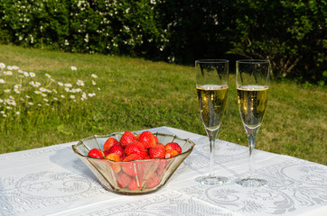 Bowl with strawberries and two glasses with champagne