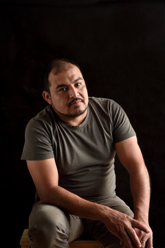 Portrait of a latin man on black background