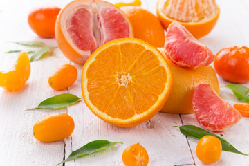 Fresh mixed fruits on vintage white wooden table.