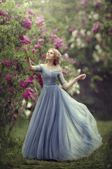 Obraz na płótnie Canvas Beautiful woman in blue dress outdoor