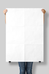 Woman holding a blank A0 poster mockup isolated on a gray background. 