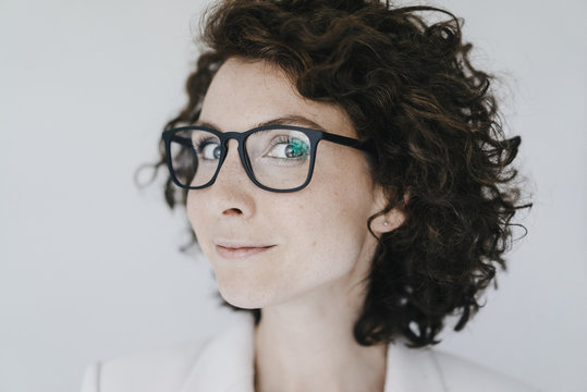 Businesswoman wearing glasses, looking confident