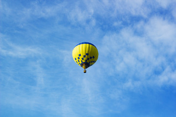 Flight of large air balloon against blue sky