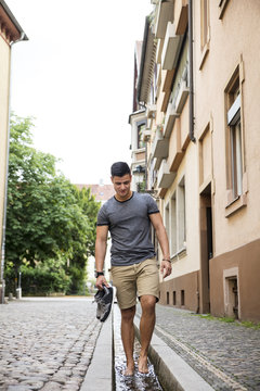 Young man wading in water in the city