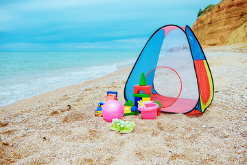 Children's tent and children's toys on the beach