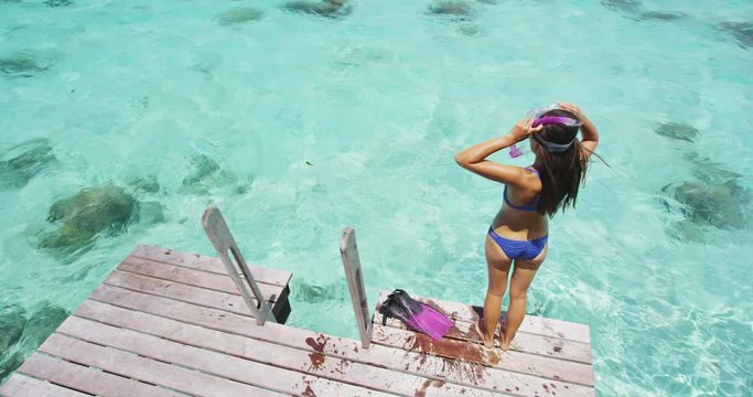 Swim girl going snorkeling with snorkel fins and diving mask. Healthy fitness active lifestyle at luxury travel resort in eco friendly nature.