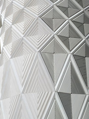 geometric diamond white patterns and cladding on wall of a modern building