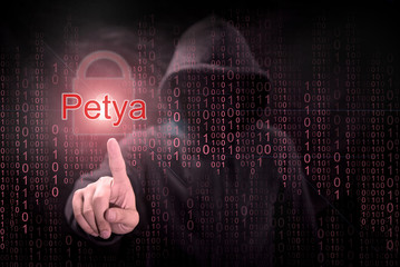 Male hacker pointing Petya or Petrwrap ransomware and red padlock symbol with digital binary code...
