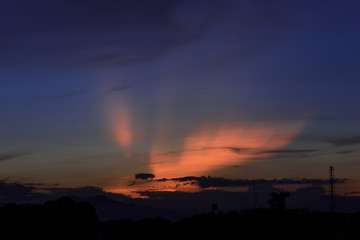 Dramatic twilight sky over city in dusk with orange and deep blue sky over city.