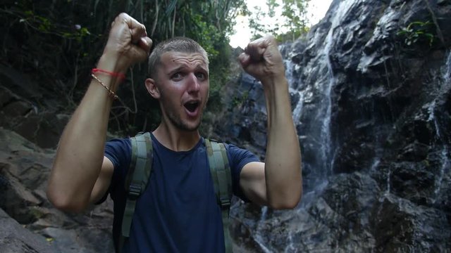 Happy Excited Hiker with Traveling Backpack At Waterfall. Slow Motion. HD, 1920x1080. 