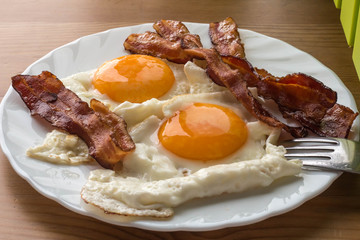 Bacon and eggs. Breakfast. Country style fried eggs with pork ham