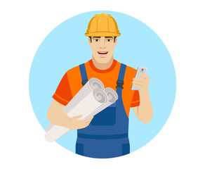 Builder holding the project plans and using mobile phone