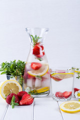 Fruit and herb infused water. Cold refreshing vitamin detox water. Summer drink