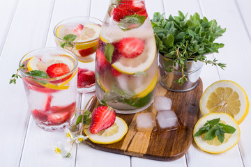 Fruit and herb infused water. Cold refreshing vitamin detox water. Summer drink